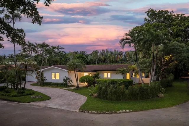 a view of house with outdoor space and garden