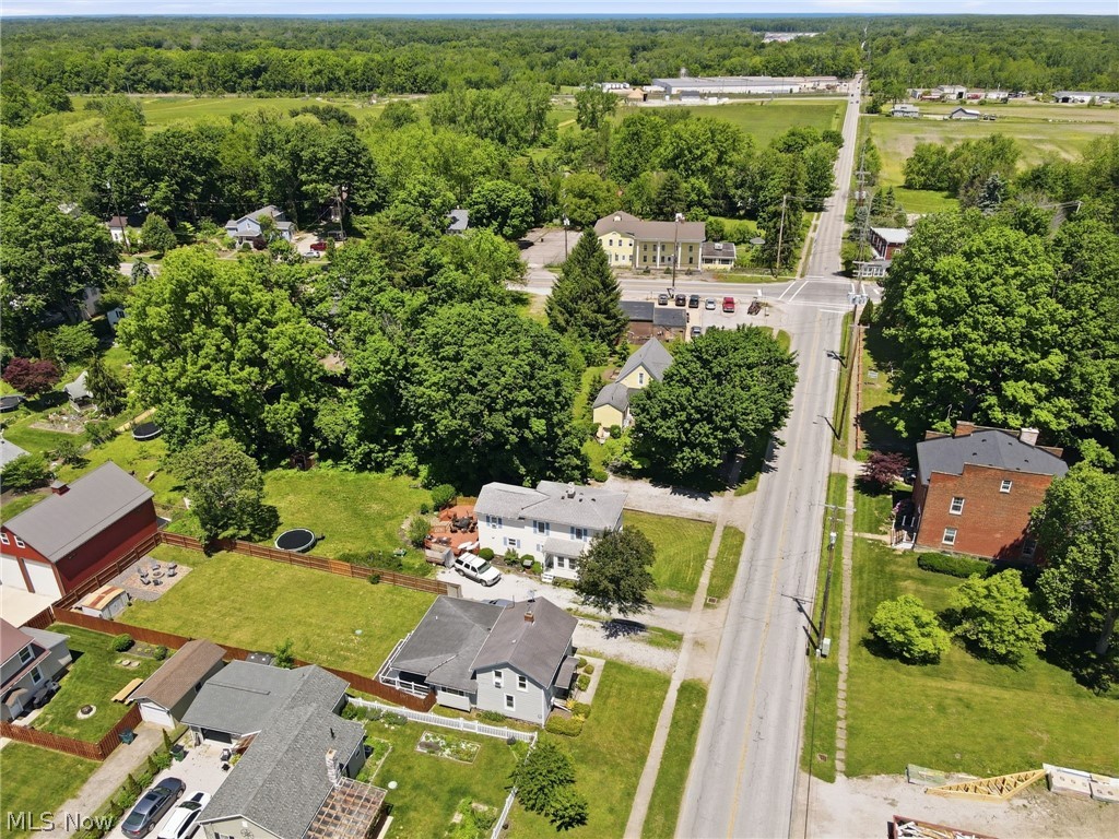 3490 County Line Road Madison, OH 44057 - Photo 40 of 42 Expansive green space and mature trees define this property, bordered by a wood fence