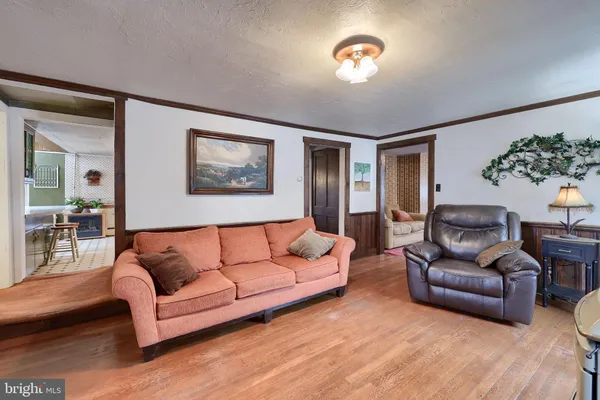 a view of a livingroom with furniture and a wooden floor