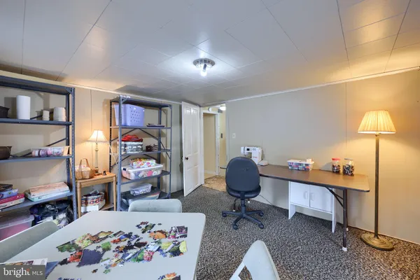 a living room with furniture and a dresser