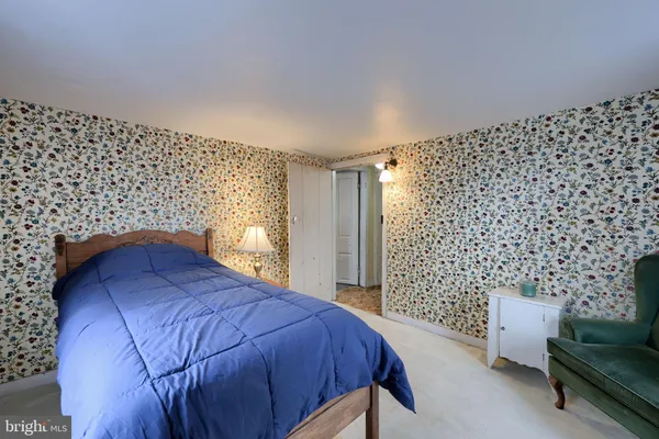 a bedroom with a bed and a couch