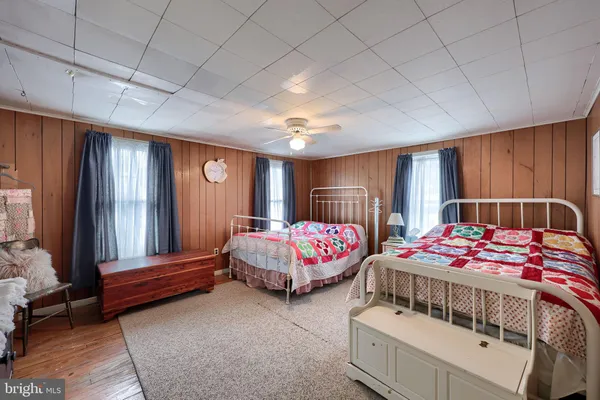 a bedroom with bed and wooden floor