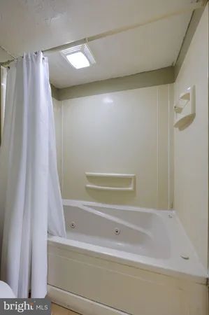 a bathroom with a shower and a tub