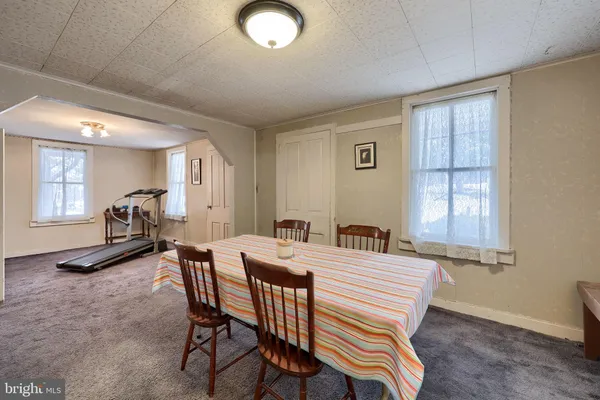 a view of a dining room with furniture and a window