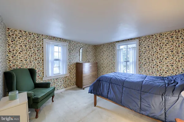 a living room with furniture a lamp and a window