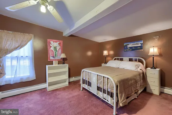 a bedroom with a bed and a night stand