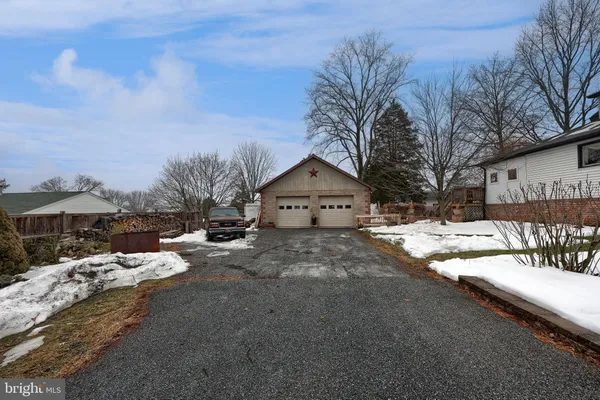 a view of a house with a yard covered in snow