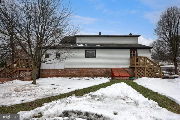 a view of a house with snow on the road