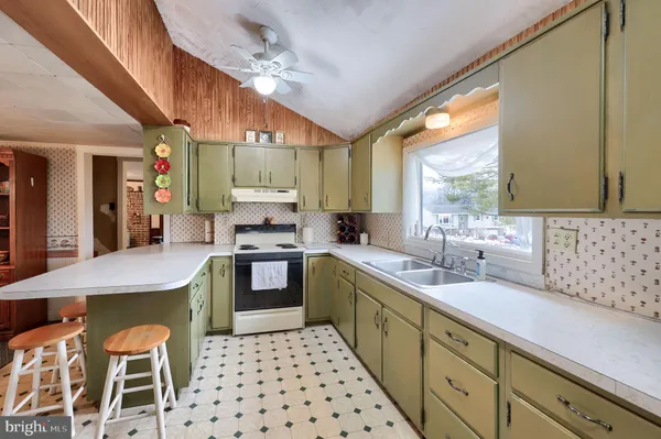 a kitchen with stainless steel appliances kitchen island granite countertop a sink and cabinets