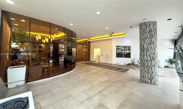 a balcony with tall trees in front of it