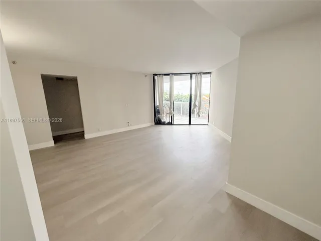 a kitchen with stainless steel appliances a refrigerator a sink a stove a washer dryer and a refrigerator