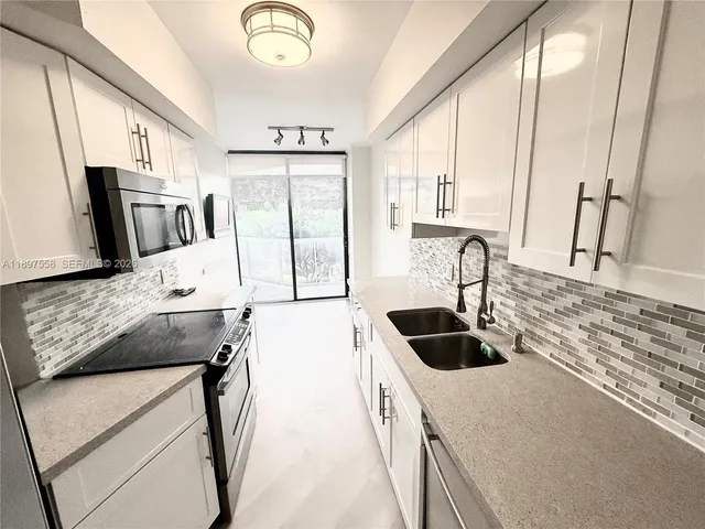 a view of a room with wooden floor and a ceiling fan