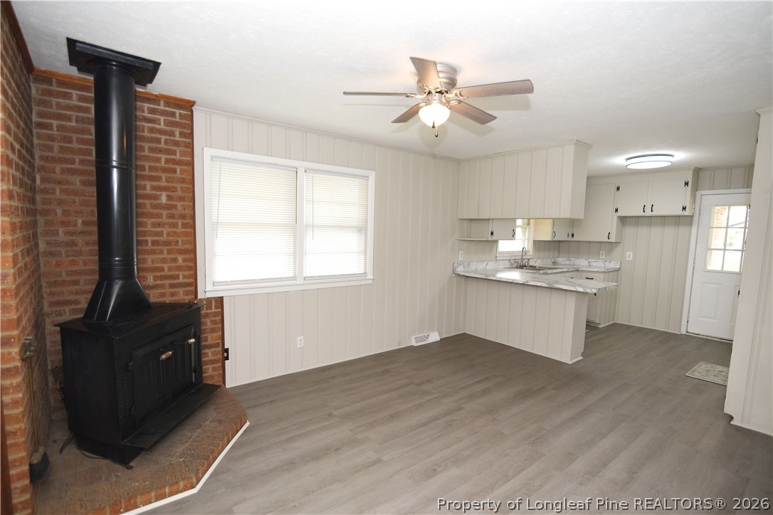 1673 Norment Road Lumberton, NC 28360 - Photo 7 of 32 a kitchen with kitchen island white cabinets and appliances