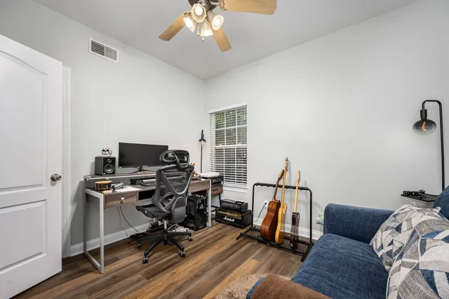 a view of a livingroom with workspace and a couch