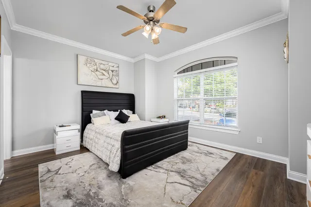 a bed sitting in a bedroom next to a window