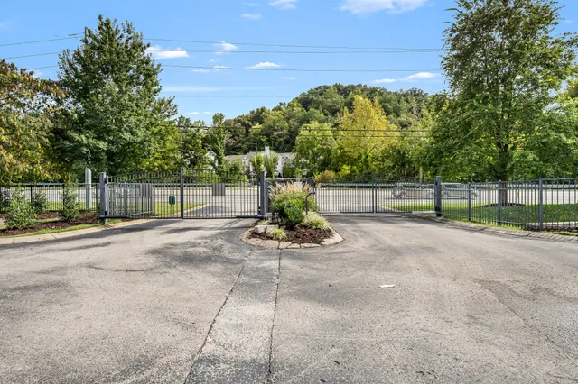 a view of a park with iron fence