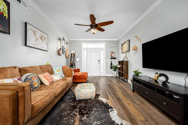 a living room with furniture and a flat screen tv