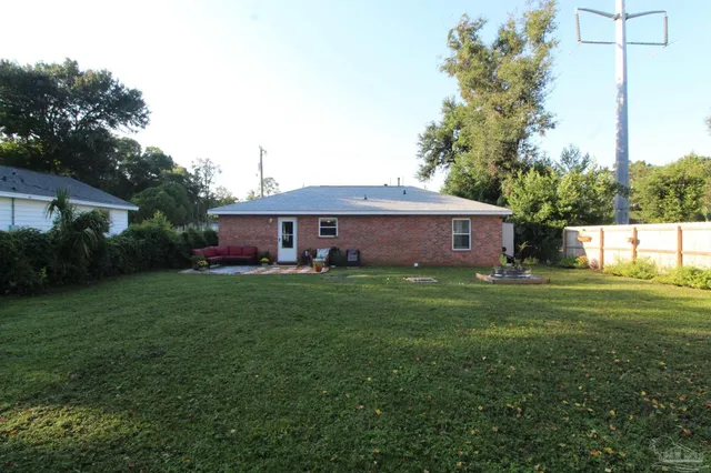 a front view of house with yard and trees