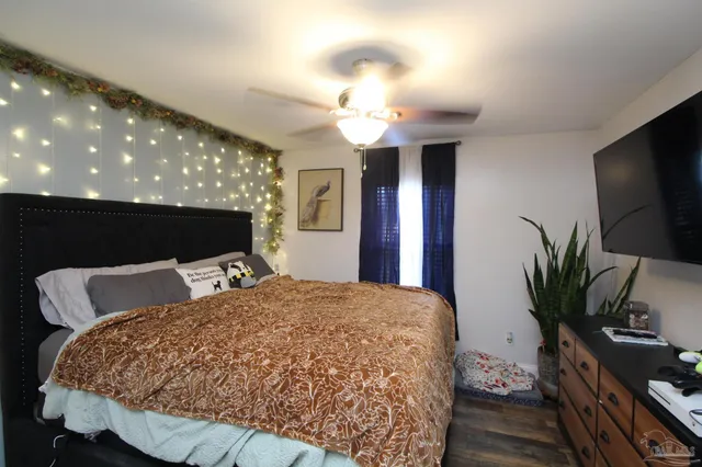 a bedroom with a large bed and a chandelier