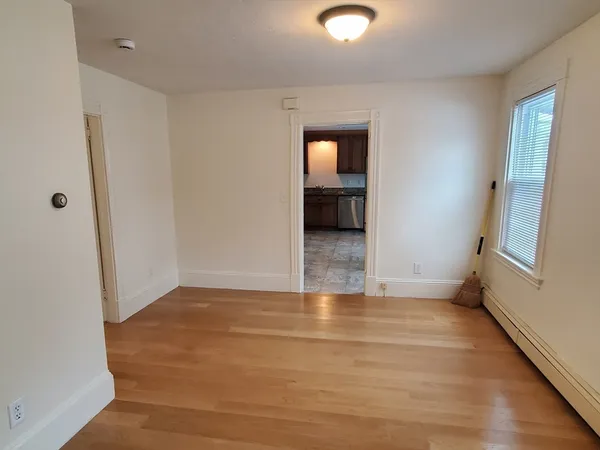 a view of hallway with a sink and a mirror