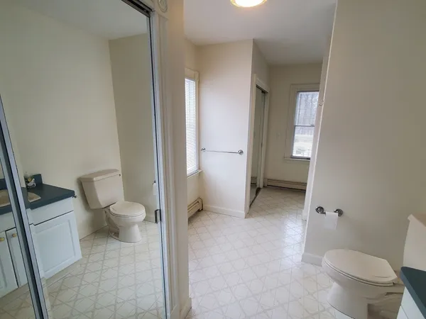 a bathroom with a toilet and a shower