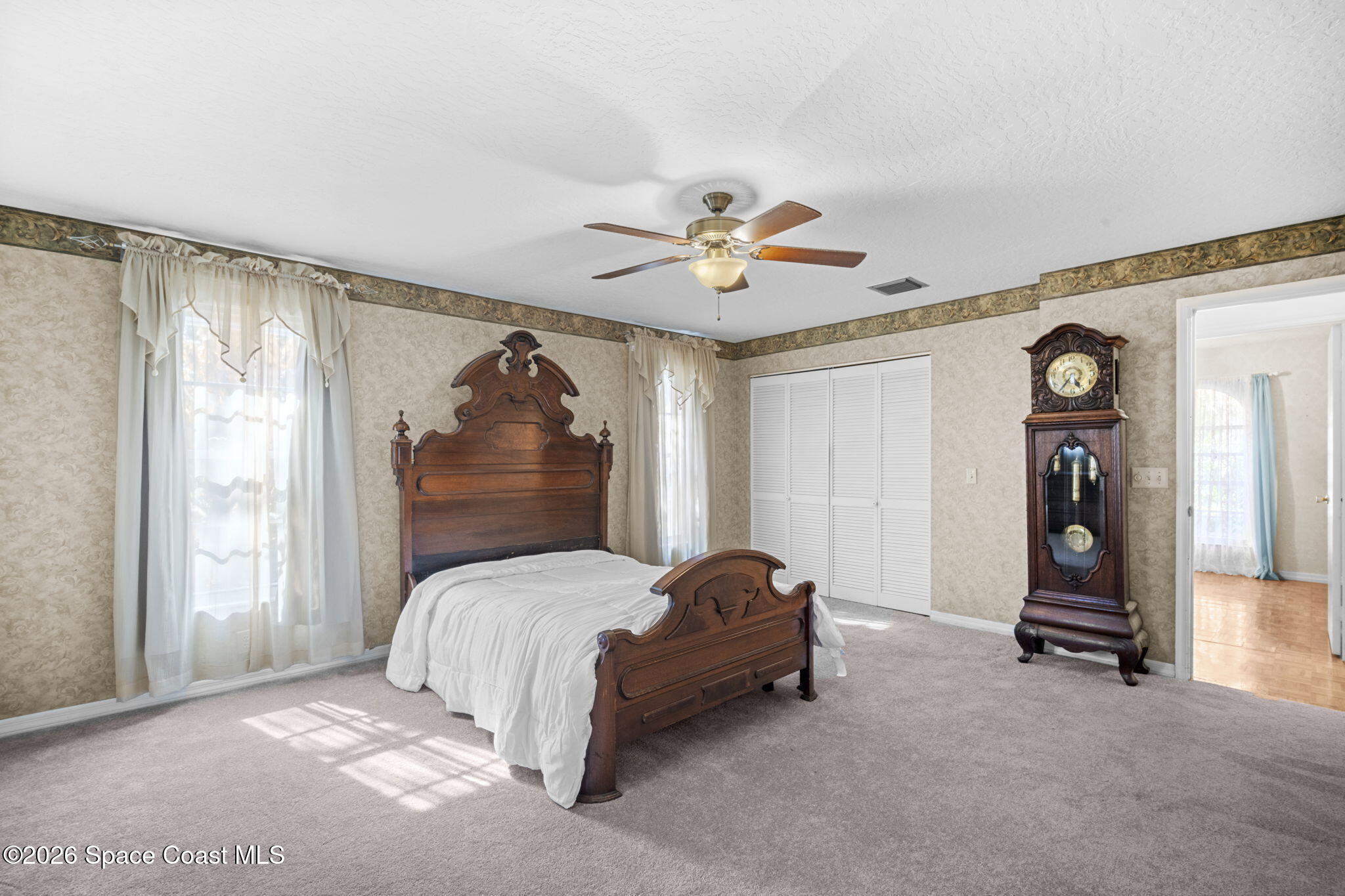 620 West Pine Road Melbourne, FL 32904 - Photo 18 of 32 a bedroom with a bed and a ceiling fan