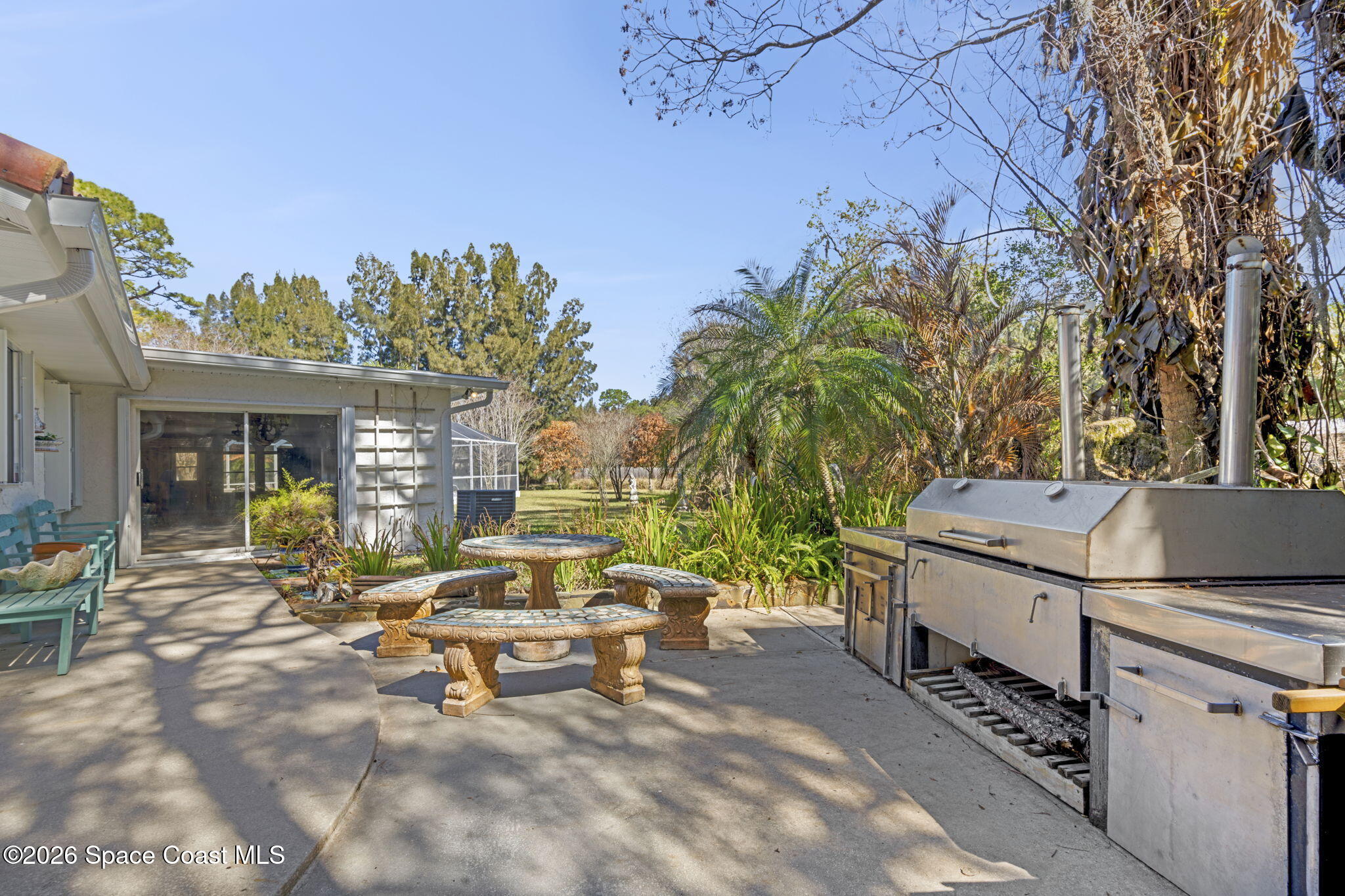 620 West Pine Road Melbourne, FL 32904 - Photo 22 of 32 a backyard of a house with yard and outdoor seating