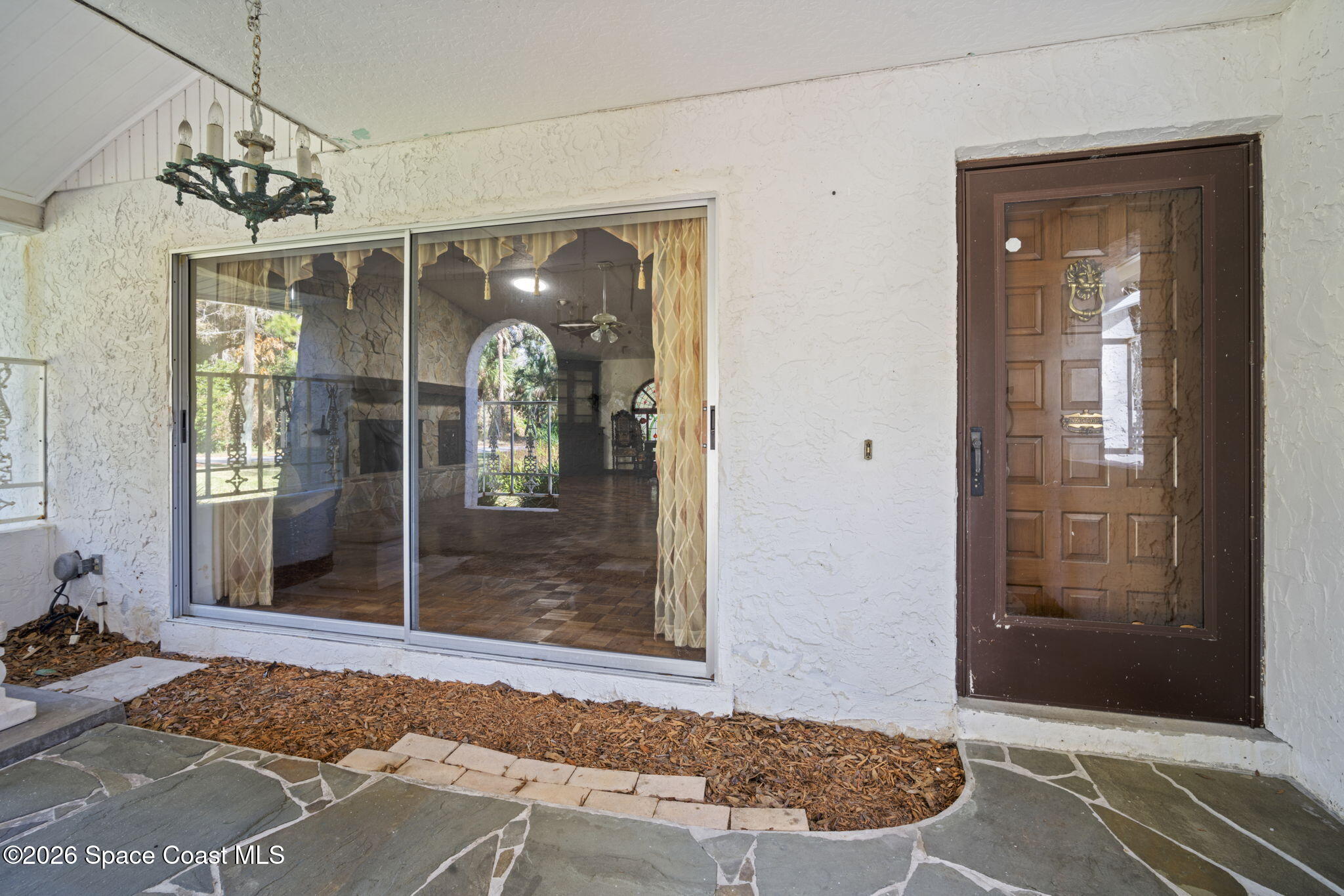 620 West Pine Road Melbourne, FL 32904 - Photo 7 of 32 a view of a hallway with wooden floor and a livingroom