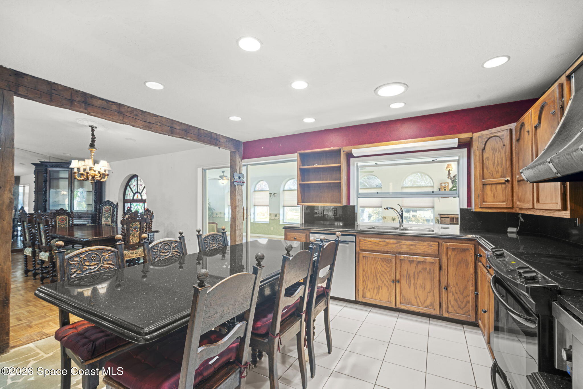 620 West Pine Road Melbourne, FL 32904 - Photo 10 of 32 a kitchen with a table chairs stove and cabinets