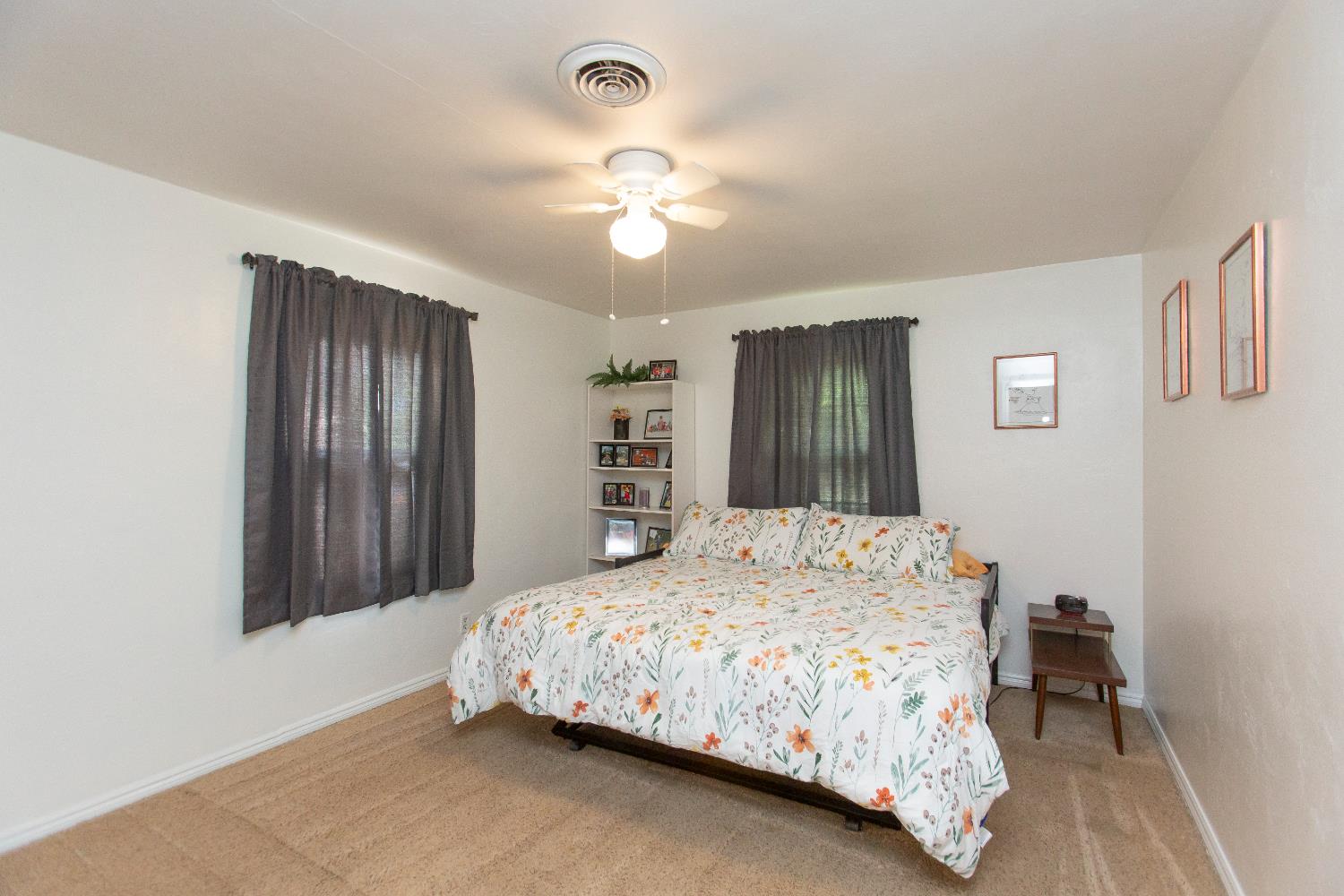 401 Fortuna Avenue Modesto, CA 95354 - Photo 15 of 43 a bedroom with a large bed and a chandelier