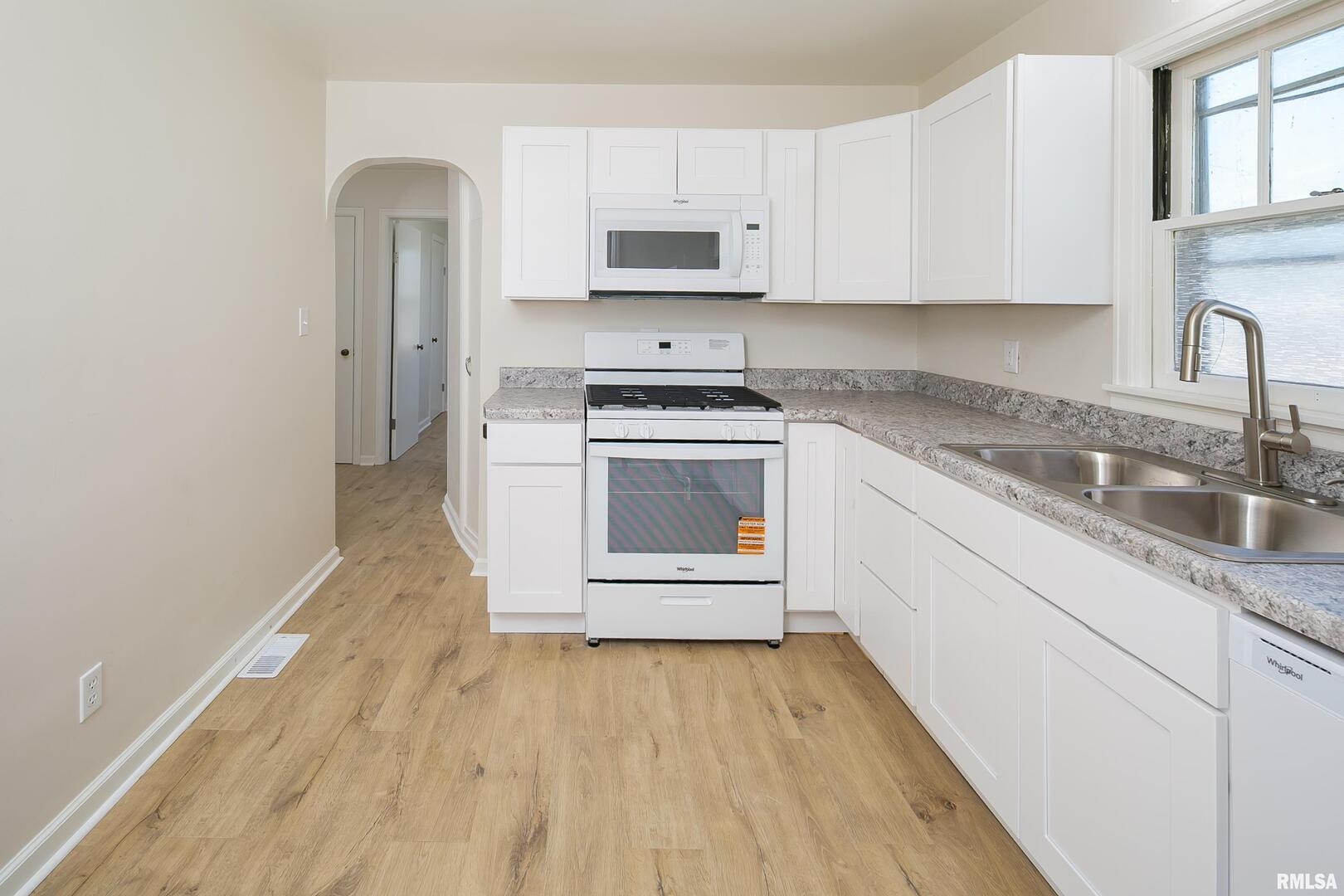 5431 3rd Avenue Moline, IL 61265 - Photo 2 of 29 a kitchen with granite countertop a stove a sink and a refrigerator