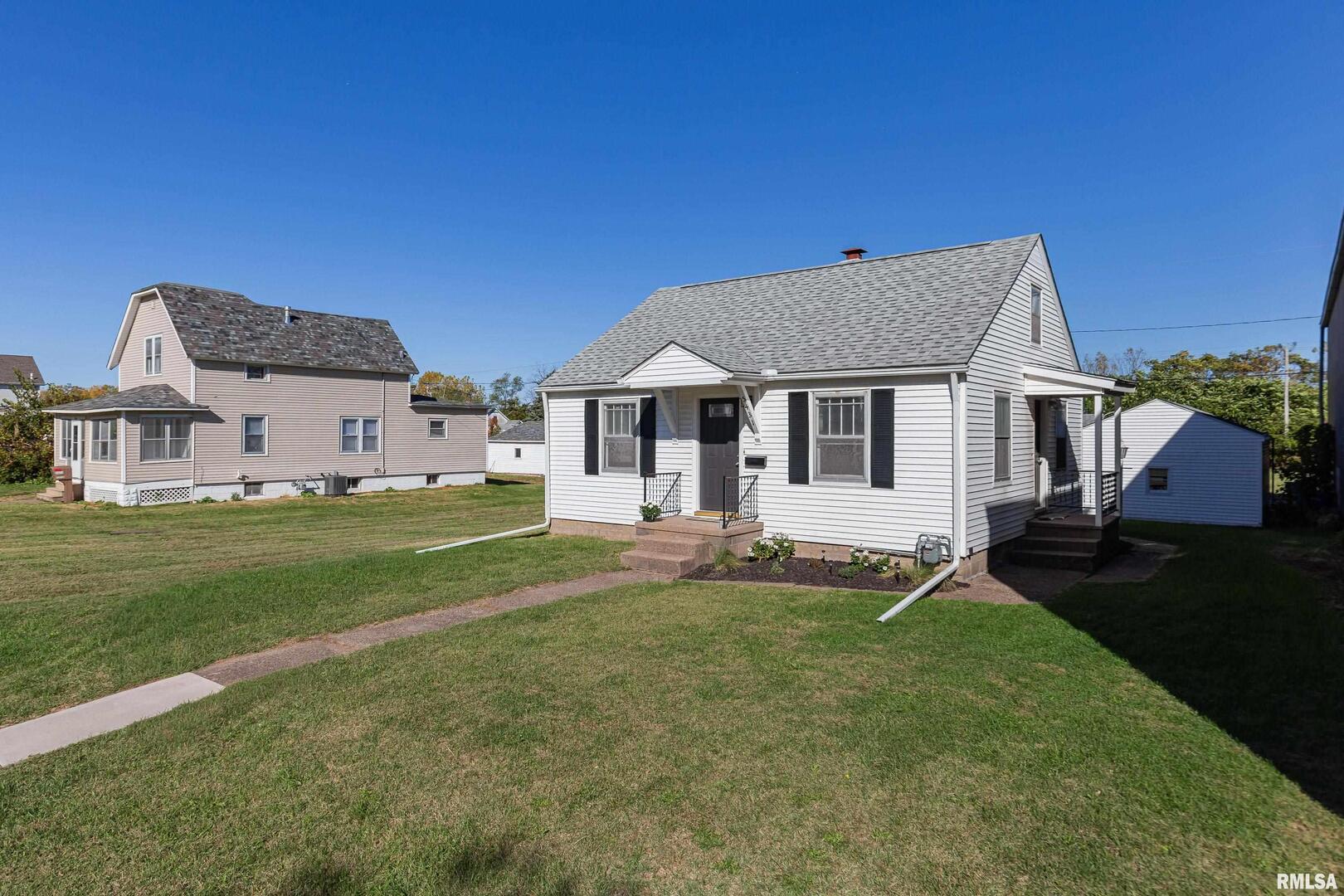 5431 3rd Avenue Moline, IL 61265 - Photo 23 of 29 a front view of a house with a garden and yard