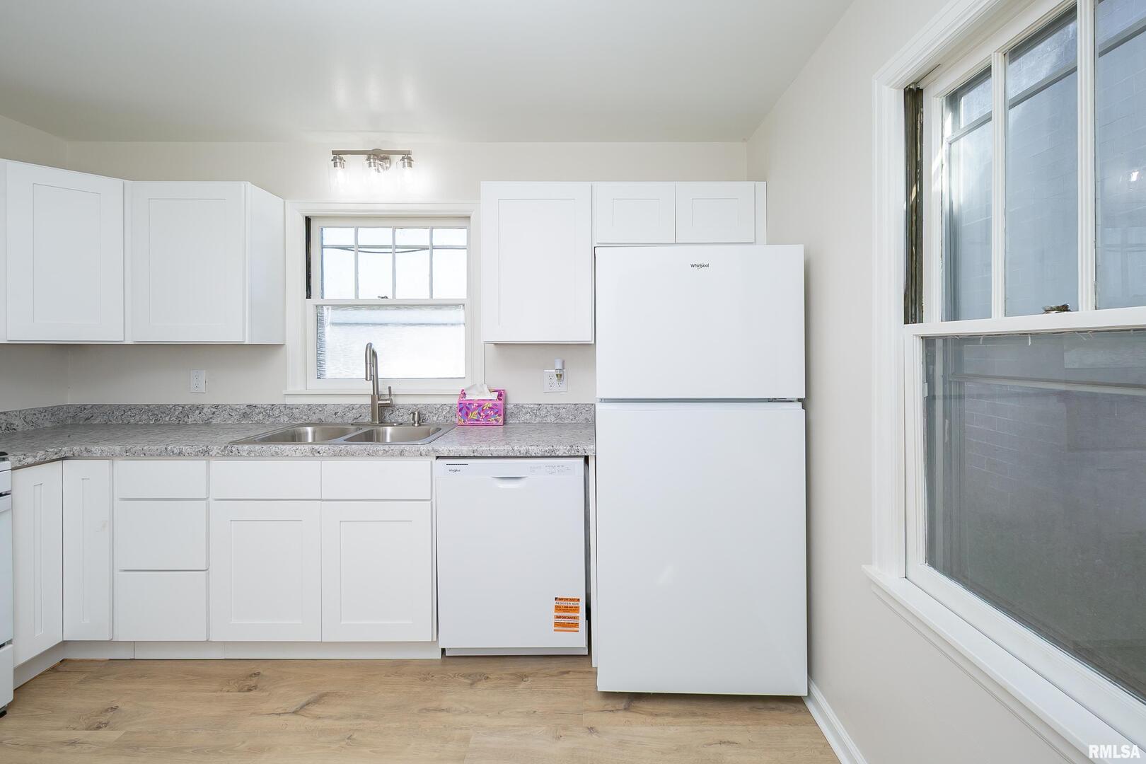 5431 3rd Avenue Moline, IL 61265 - Photo 4 of 29 a white refrigerator freezer sitting inside of a kitchen