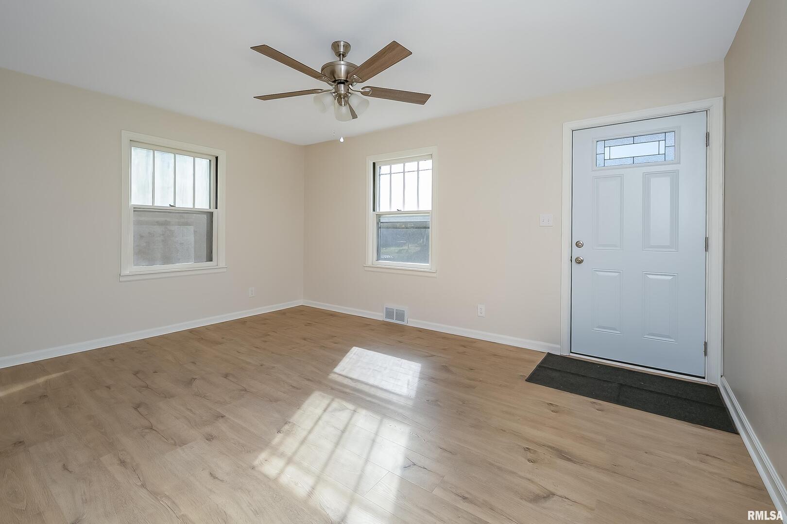 5431 3rd Avenue Moline, IL 61265 - Photo 8 of 29 an empty room with wooden floor and windows