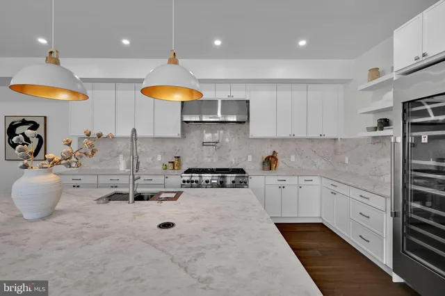 a bathroom with a bathtub sink vanity mirror and toilet