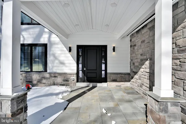 a kitchen with stainless steel appliances granite countertop a stove top oven a sink a dining table and chairs with wooden floor