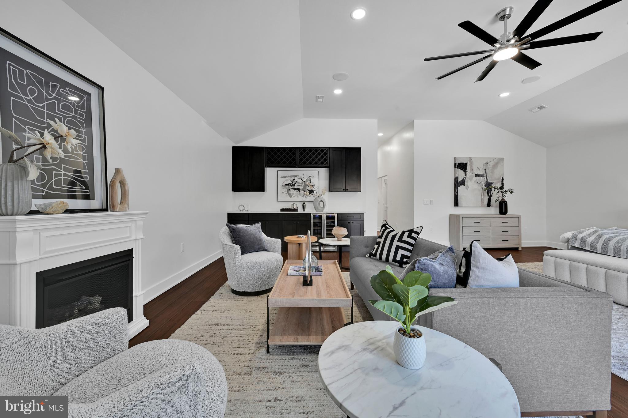780 Hobbs Road Wayne, PA 19087 - Photo 40 of 94 a living room with furniture a fireplace and a flat screen tv