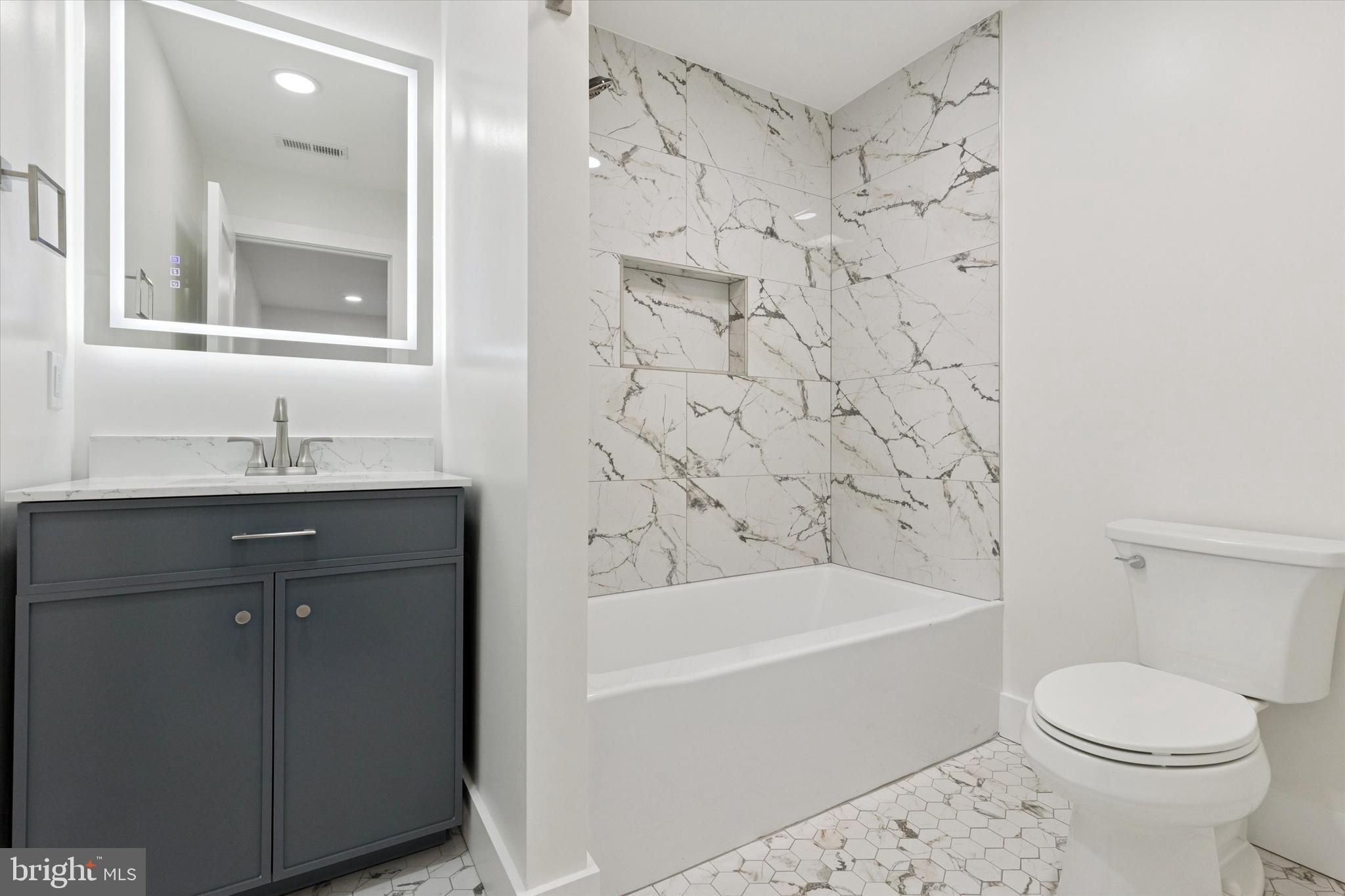 780 Hobbs Road Wayne, PA 19087 - Photo 62 of 94 a bathroom with a bathtub sink vanity mirror and toilet