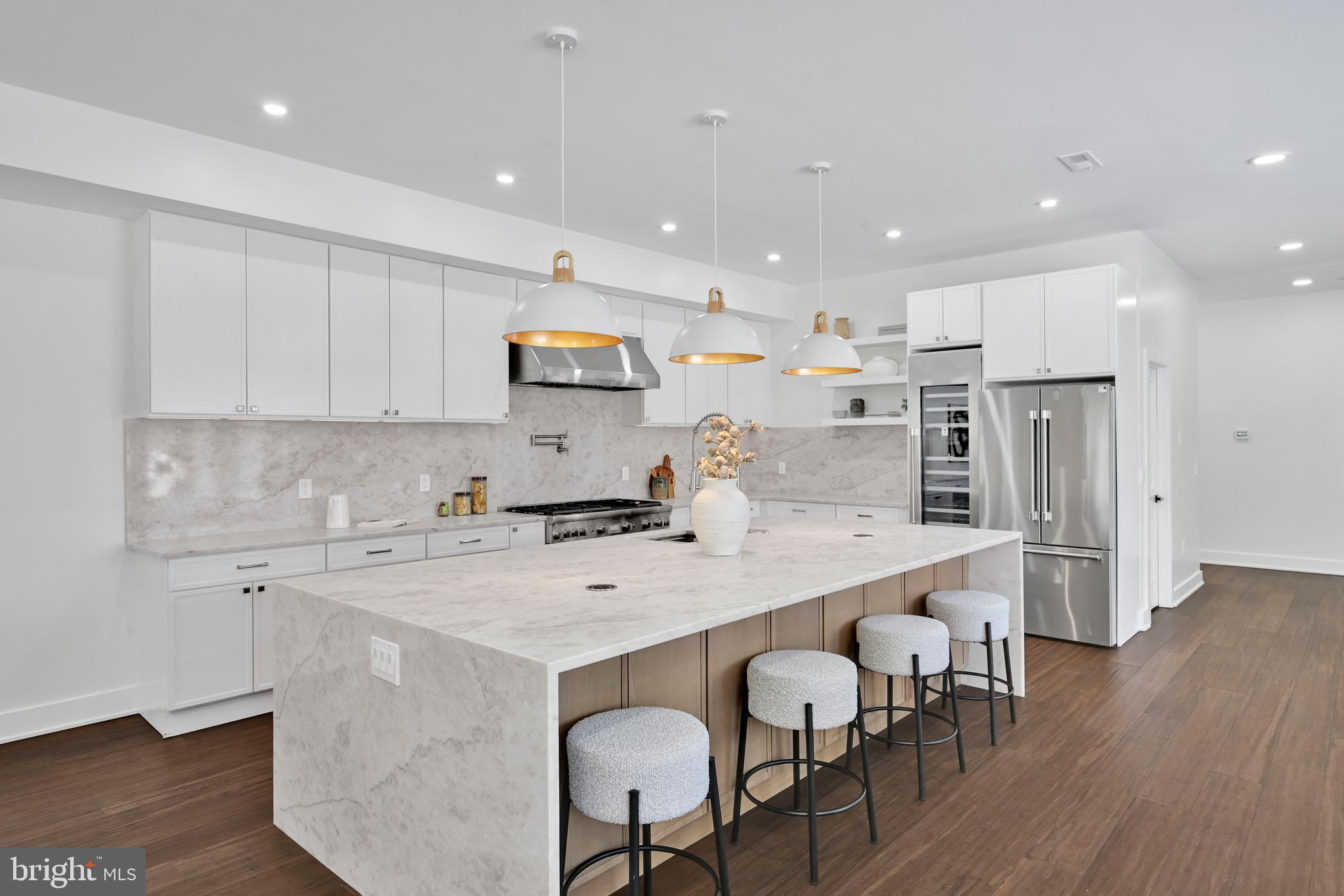 780 Hobbs Road Wayne, PA 19087 - Photo 7 of 94 a kitchen with stainless steel appliances a sink a stove a refrigerator and island with wooden floor