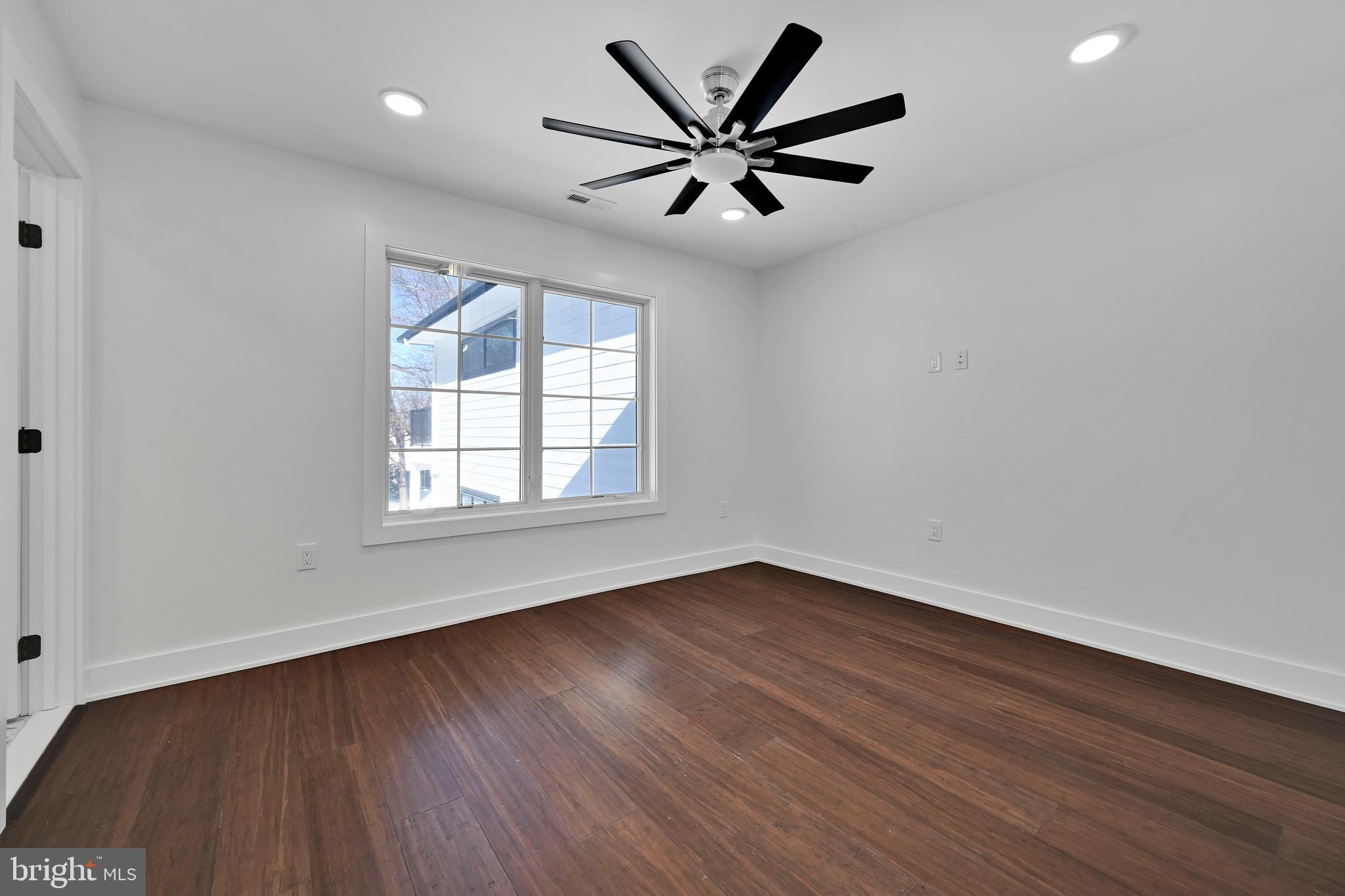 780 Hobbs Road Wayne, PA 19087 - Photo 77 of 94 an empty room with wooden floor ceiling fan and windows