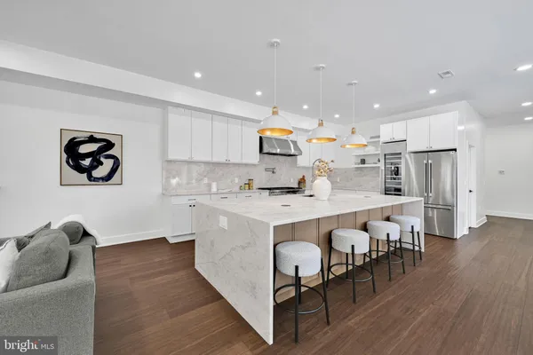 a large kitchen with stainless steel appliances kitchen island a large island in the center