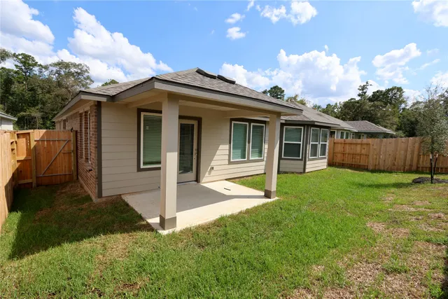 a view of a house with yard and a garden