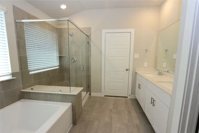 a bathroom with a tub a sink and a shower