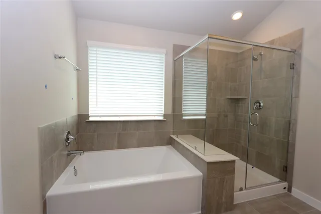 a bathroom with a bathtub and shower