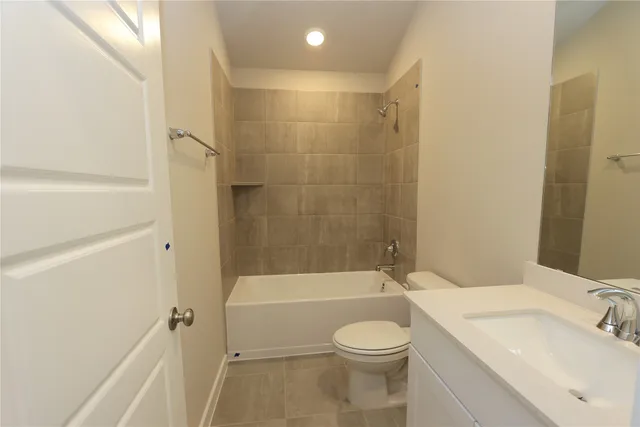 a bathroom with a toilet a sink and bathtub