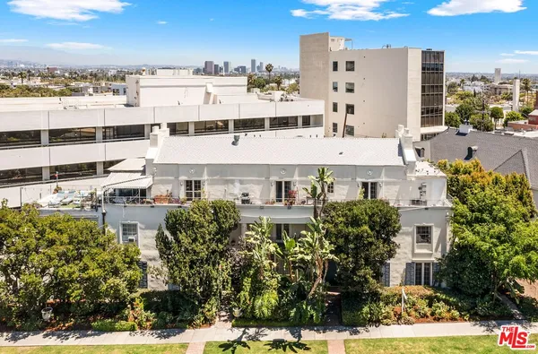 a large building with a lot of trees in front of it
