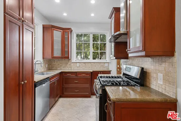 a kitchen with a sink stove and microwave