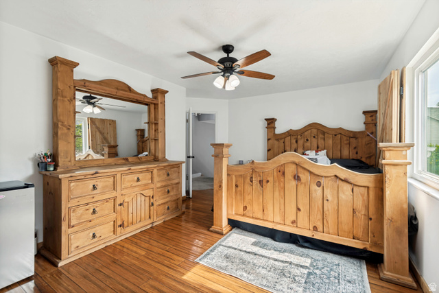 332 East Magellan Lane Elk Ridge, UT 84651 - Photo 9 of 24 Room featuring wood-finish flooring, a ceiling fan with integrated lighting, white walls, and a window with natural light