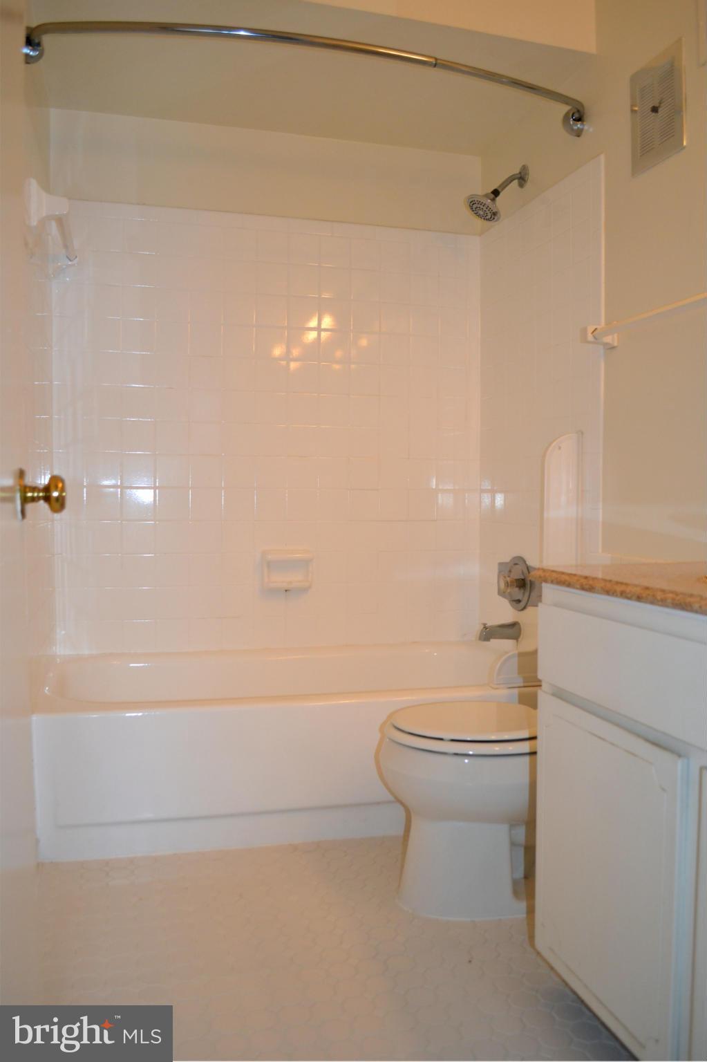 8256 Carrleigh Parkway Springfield, VA 22152 - Photo 16 of 28 a bathroom with a toilet and a shower
