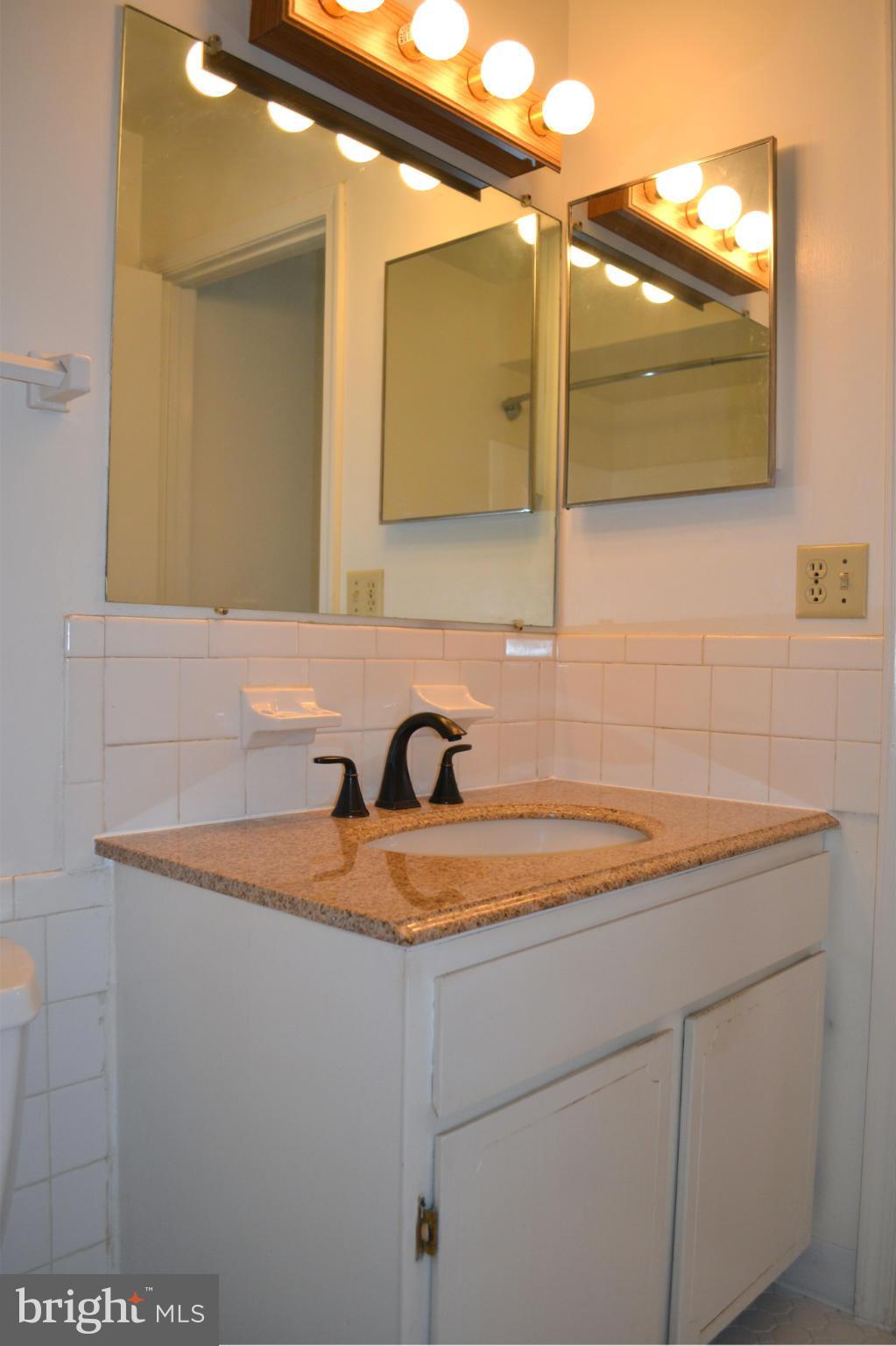 8256 Carrleigh Parkway Springfield, VA 22152 - Photo 17 of 28 a bathroom with a sink and a mirror